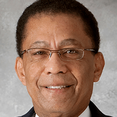 May contain a person wearing glasses and a suit.