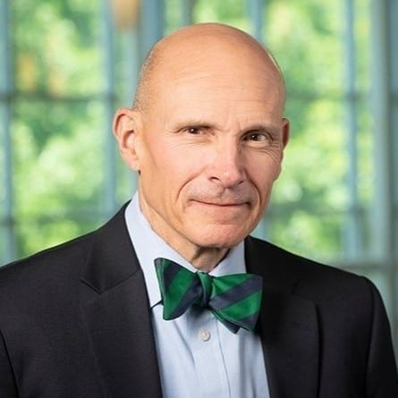 May contain a person wearing a bow tie and suit.