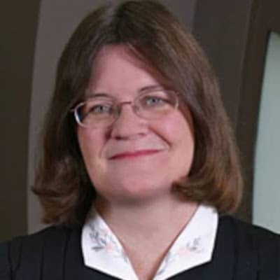 May contain a person wearing glasses and a collared shirt.