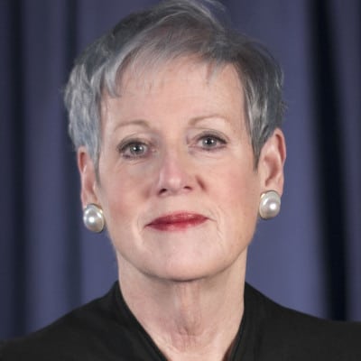 May contain a person with short gray hair and pearl earrings.