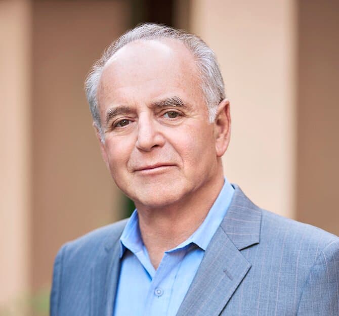 May contain one person, a person with grey hair wearing a suit.