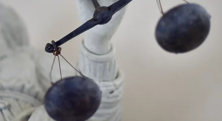 May contain a statue of a person holding scales.