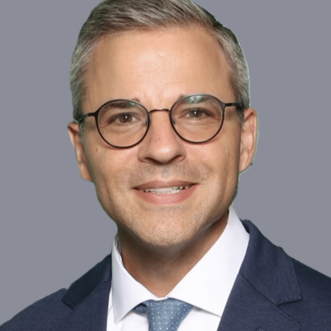 May contain a person wearing glasses and a suit.