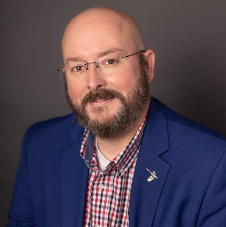 May contain one person wearing glasses and a blue blazer.