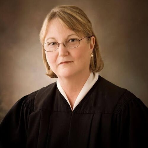 May contain one person wearing a judge's robe and glasses.