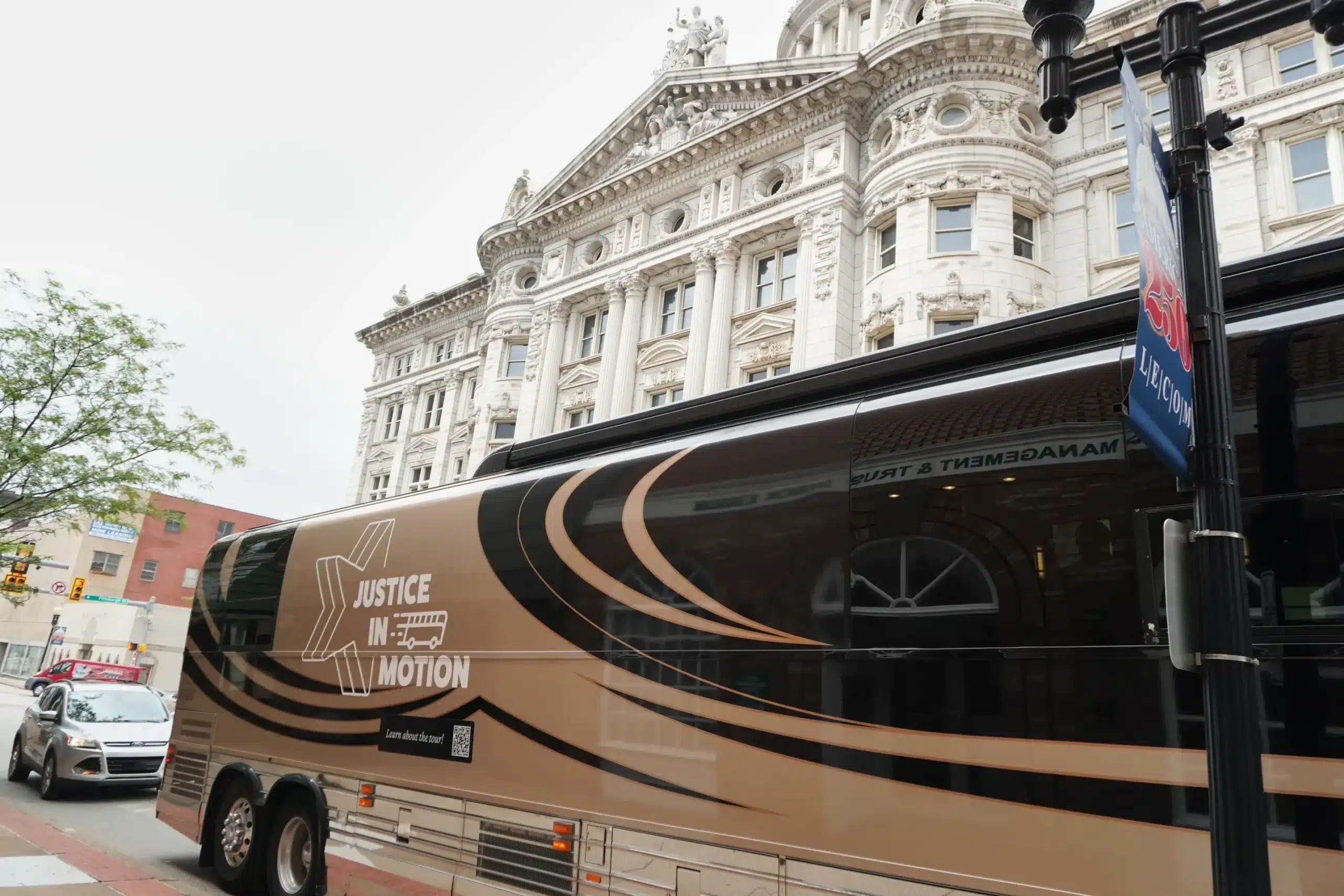 May contain a bus with "Justice in Motion" text on it.