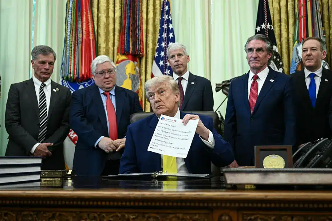 May contain six people in suits, one holding a document.