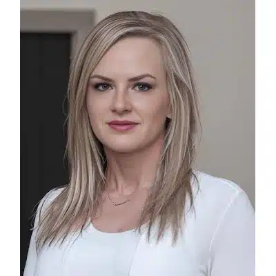 May contain a person with blonde hair wearing a white top and necklace.