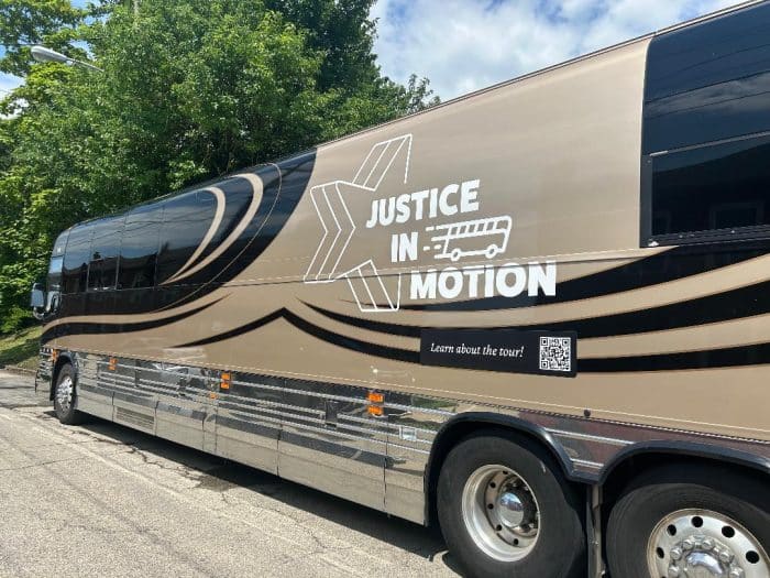 May contain a bus with "Justice in Motion" and a QR code.