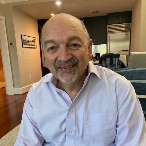 May contain one person smiling in a purple shirt.