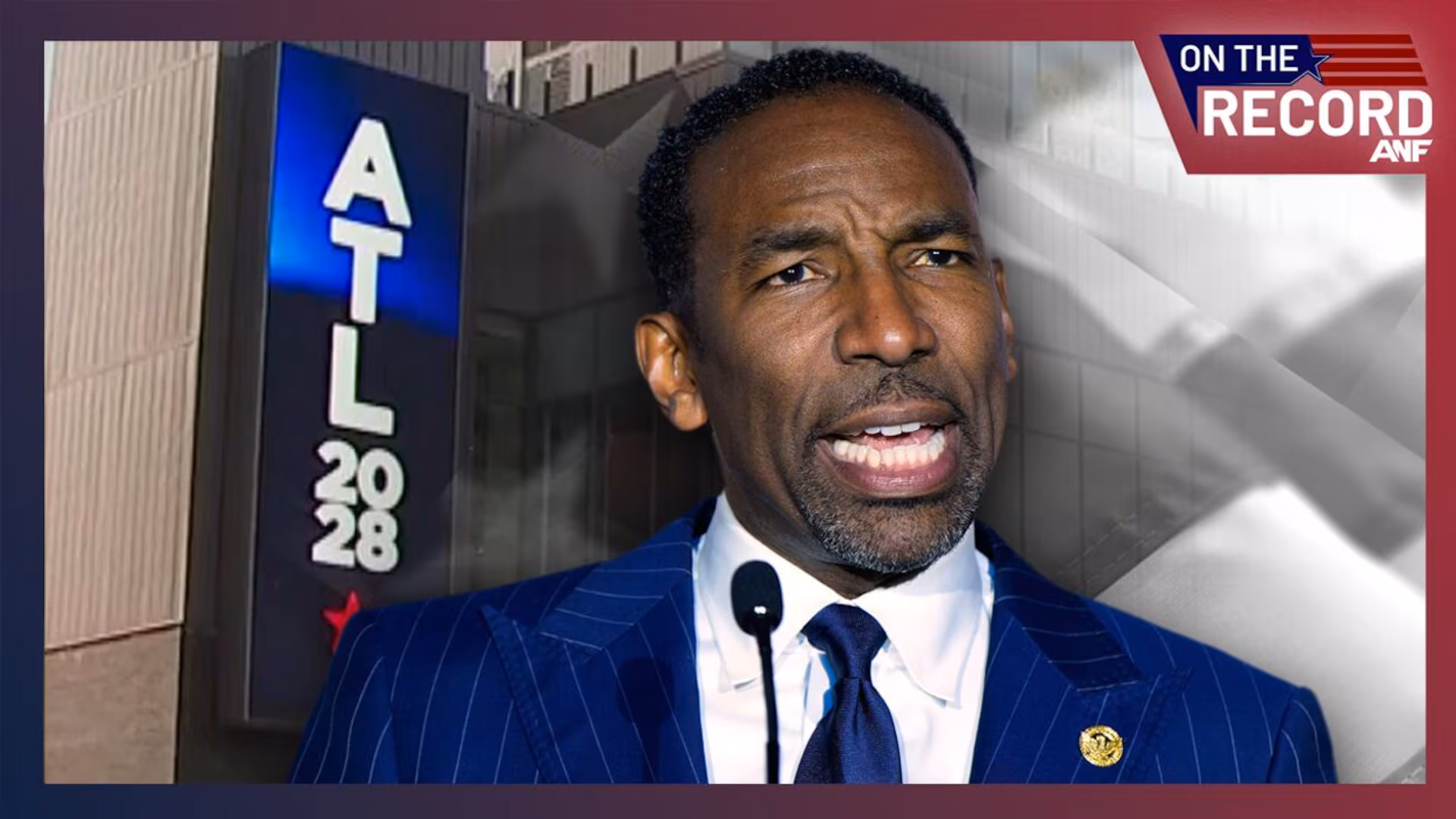 May contain a person speaking at a microphone with an ATL 2028 sign.