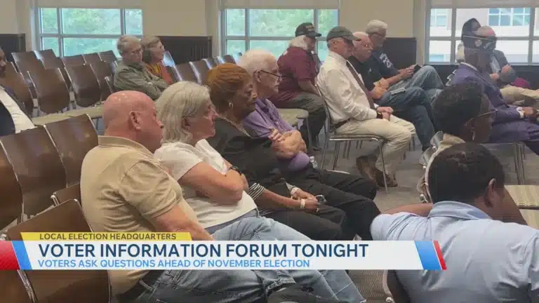May contain multiple people sitting in chairs at a forum.