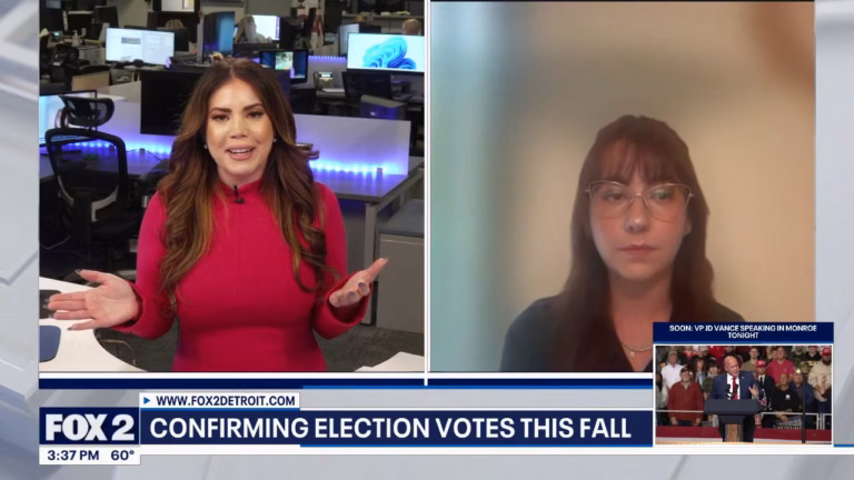May contain two people, one speaking in a studio, the other on a video call.